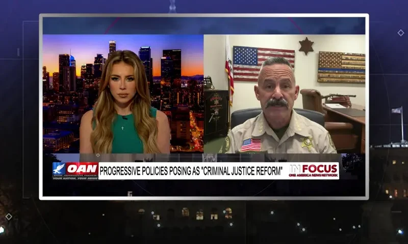 Video still from In Focus on One America News Network showing a split screen of the host on the left side, and on the right side is the guest, Sheriff Chad Bianco.