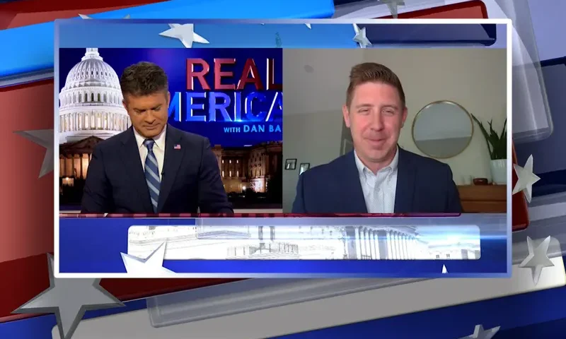 Video still from Real America on One America News Network showing a split screen of the host on the left side, and on the right side is the guest, David Covey.