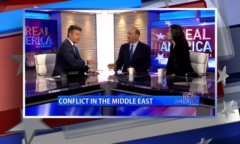 Video still from Real America on One America News Network during an interview with the guests, Dr. Walid Phares and Gazelle Sharmahd.