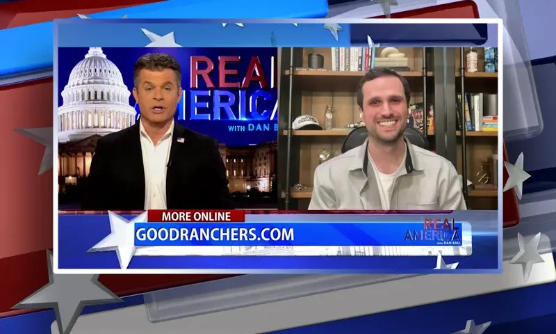 Video still from Real America on One America News Network showing a split screen of the host on the left side, and on the right side is the guest, Michael McWhorter.