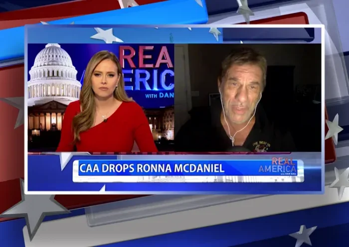 Video still from Real America on One America News Network showing a split screen of the host on the left side, and on the right side is the guest, Robert Davi.