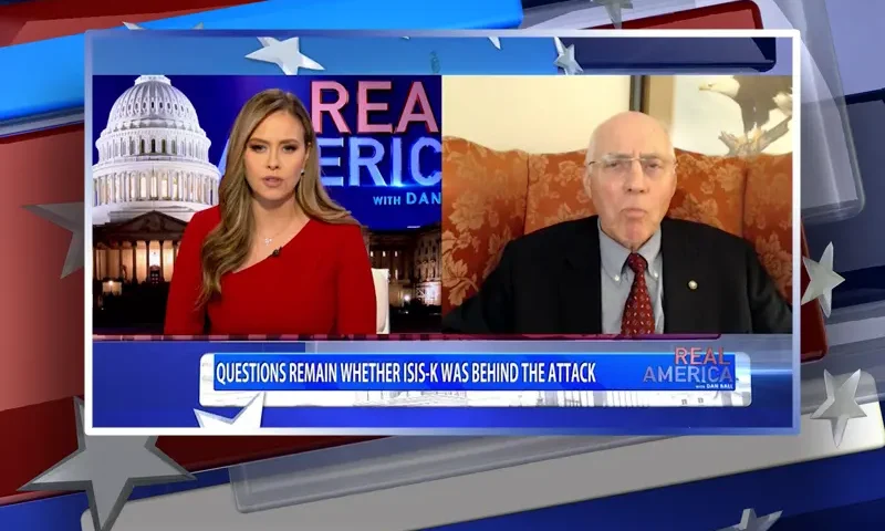 Video still from Real America on One America News Network showing a split screen of the host on the left side, and on the right side is the guest, Lt. Col. Robert Maginnis (RET.) .