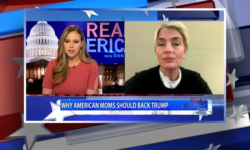 Video still from Real America on One America News Network showing a split screen of the host on the left side, and on the right side is the guest, Carolyn Phippen.