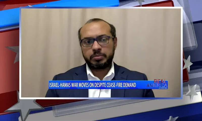 Video still from Real America on One America News Network during an interview with the guest, Khaled Hassan.