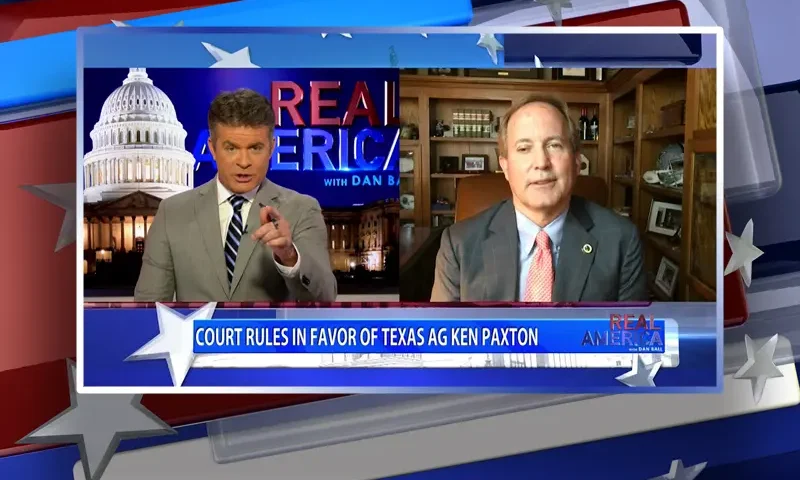Video still from Real America on One America News Network showing a split screen of the host on the left side, and on the right side is the guest, AG Ken Paxton.
