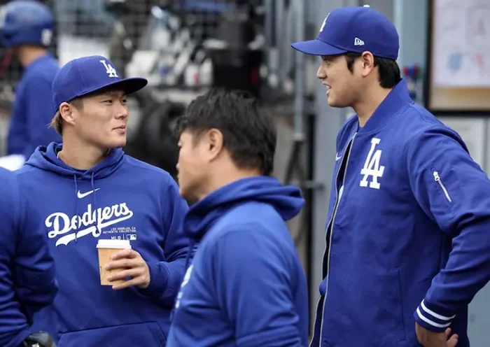 Los Angeles Dodgers designated hitter Shohei Ohtani (R) talks with starting pitcher Yoshinobu Yamamoto (L) during the game against the Los Angeles Angels at Dodger Stadium. Mandatory Credit: Kiyoshi Mio-USA TODAY Sports/FILE PHOTO
