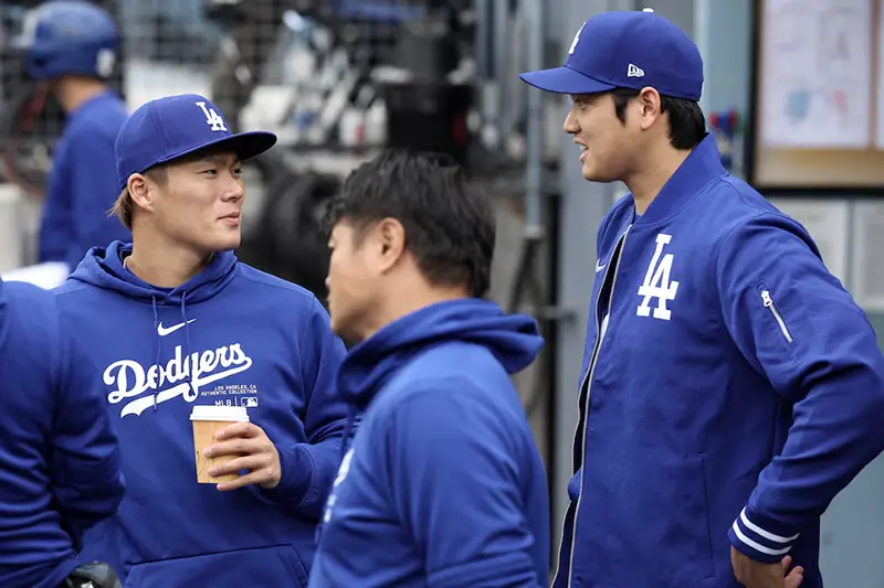 Los Angeles Dodgers designated hitter Shohei Ohtani (R) talks with starting pitcher Yoshinobu Yamamoto (L) during the game against the Los Angeles Angels at Dodger Stadium. Mandatory Credit: Kiyoshi Mio-USA TODAY Sports/FILE PHOTO