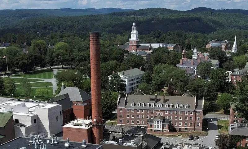 A chimney stack rises out of Dartmouth College's Heating Plant in Hanover, New Hampshire, U.S., August 25, 2022. REUTERS/Brian Snyder/File Photo