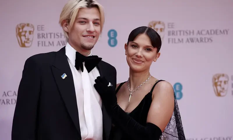 Millie Bobby Brown and Jake Bongiovi arrive at the 75th British Academy of Film and Television Awards (BAFTA) at the Royal Albert Hall in London, Britain, March 13, 2022. REUTERS/Henry Nicholls/File Photo
