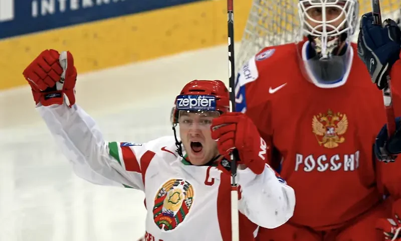 Belarus' Konstantin Koltsov (L) celebrates a goal against Russia during their IIHF World Hockey Championship quarterfinal game in Bern May 6, 2009. REUTERS/Michael Buholzer/File Photo