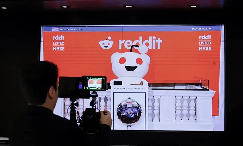 A person records the Reddit mascot as it rings the opening bell, at the New York Stock Exchange (NYSE) in New York City, U.S., March 21, 2024. REUTERS/Brendan McDermid