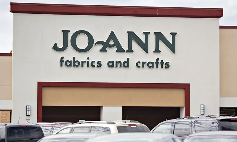 A Jo-Ann Stores Inc. Location As Yarn And Fabric Stay on Trump's Tariff List Vehicles sit in the parking lot outside a Jo-Ann Store LLC location in Davenport, Iowa, U.S., on Wednesday, Sept. 19, 2018. Joann, the crafting and arts supplies chain which dropped Fabrics from its name earlier this year, tried to make the case that many small businesses shop at its stores for supplies to make locally produced goods, leading it to dub Trump's tariffs a "made-in-America tax." Photographer: Daniel Acker/Bloomberg via Getty Images