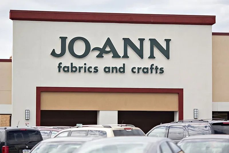 A Jo-Ann Stores Inc. Location As Yarn And Fabric Stay on Trump's Tariff List
Vehicles sit in the parking lot outside a Jo-Ann Store LLC location in Davenport, Iowa, U.S., on Wednesday, Sept. 19, 2018. Joann, the crafting and arts supplies chain which dropped Fabrics from its name earlier this year, tried to make the case that many small businesses shop at its stores for supplies to make locally produced goods, leading it to dub Trump's tariffs a "made-in-America tax." Photographer: Daniel Acker/Bloomberg via Getty Images
