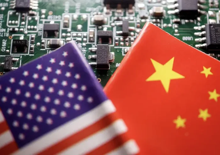 Flags of China and U.S. are displayed on a printed circuit board with semiconductor chips, in this illustration picture taken February 17, 2023. REUTERS/Florence Lo/Illustration/File Photo