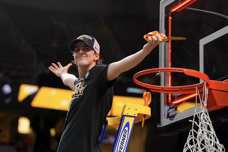Iowa Hawkeyes guard Caitlin Clark (22) cuts the net after defeating the LSU Lady Tigers in the finals of the Albany Regional in the 2024 NCAA Tournament at MVP Arena. Mandatory Credit: Gregory Fisher-USA TODAY Sports