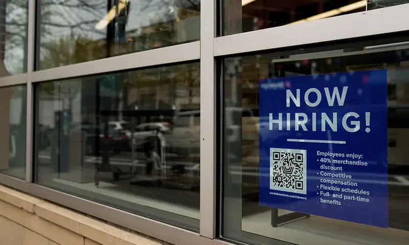 An employee hiring sign with a QR code is seen in a window of a business in Arlington, Virginia, U.S., April 7, 2023. REUTERS/Elizabeth Frantz/File Photo