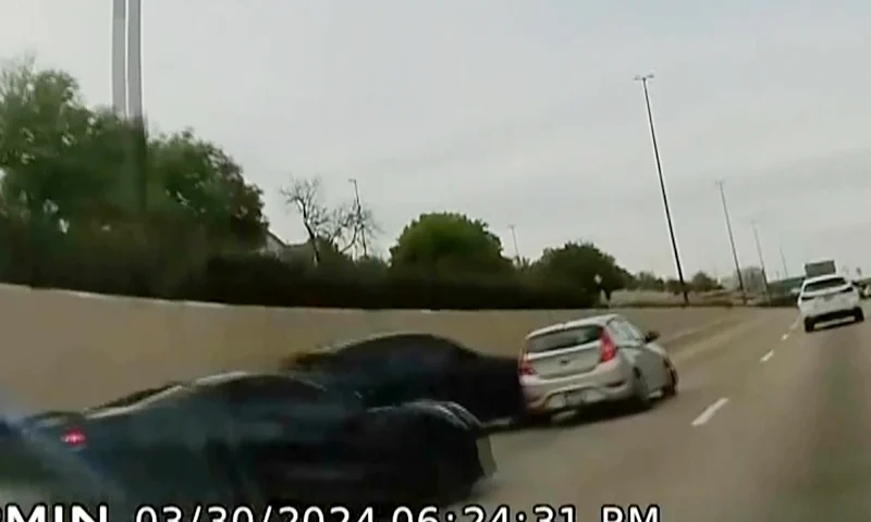 In this screen grab taken from dash camera video provided by Bill Nabors, two speeding sports cars, left and second from left, cause a chain-reaction crash on the North Central Expressway, in Dallas, Saturday, March 30, 2024. Dallas police said Wednesday, April 10, that Kansas City Chiefs' wide receiver Rashee Rice faces charges including aggravated assault after he and another speeding driver of a sports car caused a chain-reaction crash on a Dallas highway. (Bill Nabors via AP)