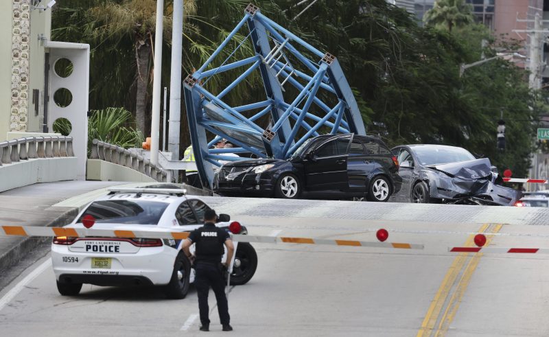 A construction worker was killed and two people were taken to the hospital after a portion of a crane dropped onto the Southeast Third Avenue bridge over the New River in downtown Fort Lauderdale, Fla., Thursday afternoon, April 4, 2024. (Carline Jean/South Florida Sun-Sentinel via AP)