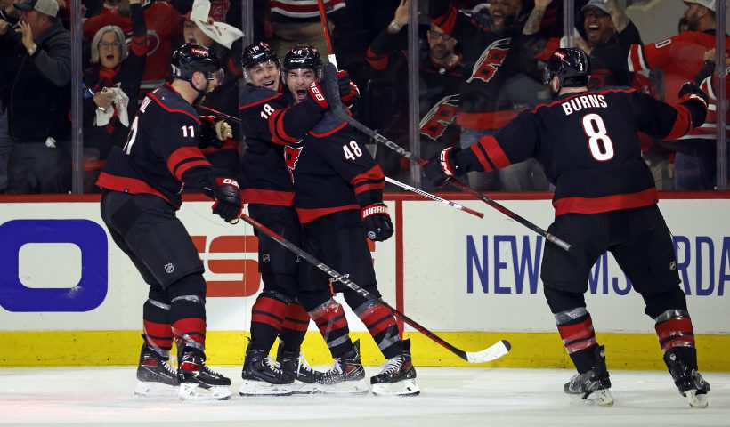 Carolina Hurricanes' Jordan Martinook (48) celebrates after his winning goal with teammates Jack Drury (18), Jordan Staal (11) and Brent Burns (8) during the third period in Game 2 of an NHL hockey Stanley Cup first-round playoff series against the New York Islanders in Raleigh, N.C., Monday, April 22, 2024. (AP Photo/Karl B DeBlaker)