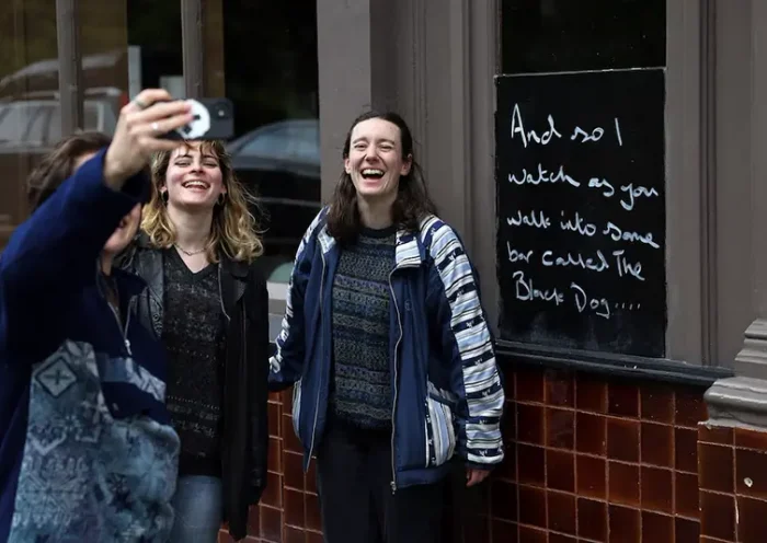 Fans of Taylor Swift take images next to lyrics from the song The Black Dog by Taylor Swift, written outside The Black Dog pub, believed by its owners to have been referenced in the track, in London, Britain, April 22, 2024. REUTERS/Toby Melville