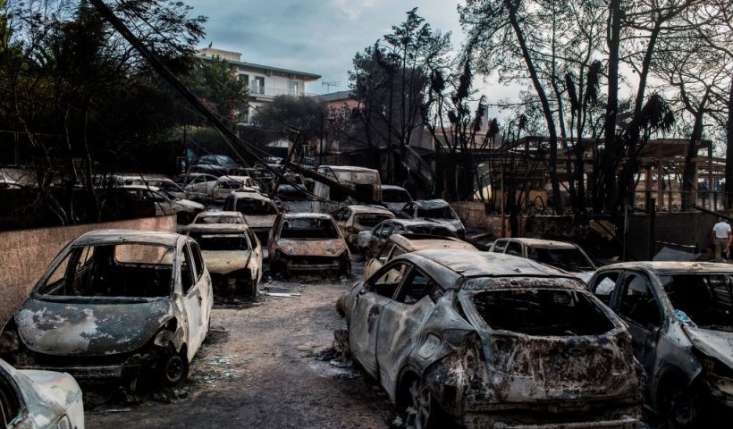 TOPSHOT - This photo taken on July 24, 2018 show cars burnt following a wildfire at the village of Mati, near Athens, on July 24, 2018. - Fifty people have died and 170 have been injured in wildfires ravaging woodland and villages in the Athens region, as Greek authorities rush to evacuate residents and tourists stranded on beaches along the coast on July 24, 2018. The death toll soared with a Red Cross official reporting the discovery of 26 bodies in the courtyard of a villa at the seaside resort of Mati. (Photo by ANGELOS TZORTZINIS / AFP) (Photo by ANGELOS TZORTZINIS/AFP via Getty Images)