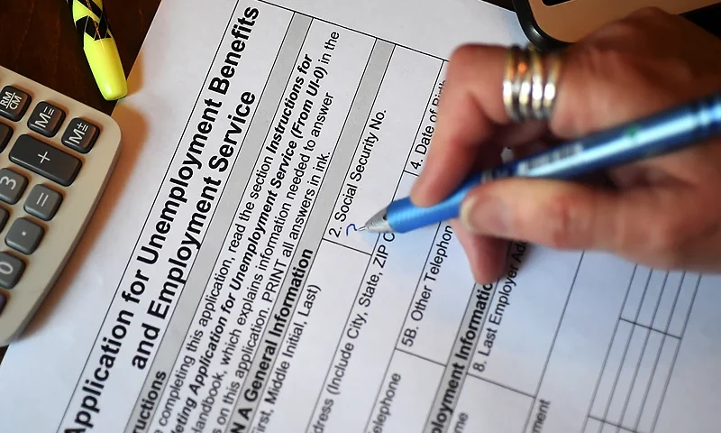 In this photo illustration, a person files an application for unemployment benefits on April 16, 2020, in Arlington, Virginia. - The government reported Thursday that another 5.2 million US workers filed for unemployment benefits, taking the four-week total to 22 million, a staggering figure in a downturn that economists say presents the country with its most severe outlook since the Great Depression of the 1930s. (Photo by Olivier DOULIERY / AFP) (Photo by OLIVIER DOULIERY/AFP via Getty Images)