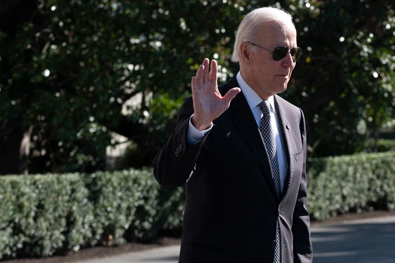 US President Joe Biden waves to the media as he departs the White House on October 6, 2022 in Washington, DC. - Biden is traveling to New York and New Jersey to speak about the economy, attend a Democratic National Committee event and participate in a Senatorial Campaign Committee before returning to Washington. (Photo by ROBERTO SCHMIDT / AFP) (Photo by ROBERTO SCHMIDT/AFP via Getty Images)