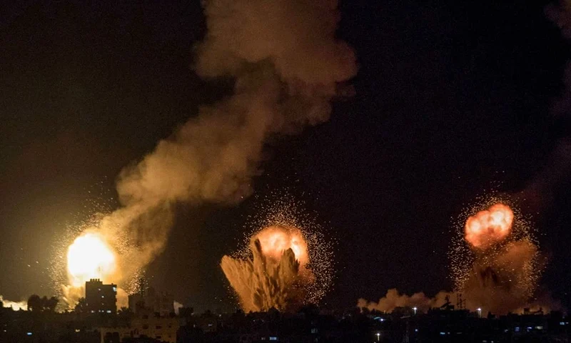 TOPSHOT - This picture taken early on April 7, 2023 shows explosions in Khan Yunis in the southern Gaza Strip during Israeli air strikes on the Palestinian enclave. (Photo by YOUSEF MASOUD / AFP) (Photo by YOUSEF MASOUD/AFP via Getty Images)