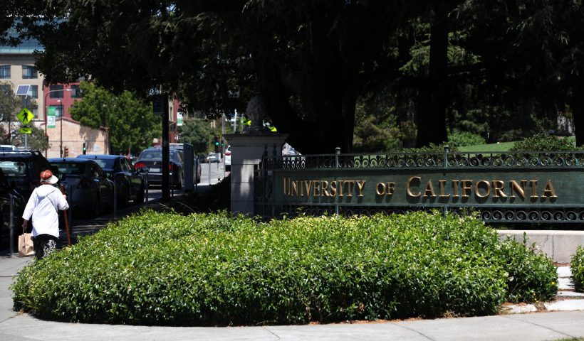 BERKELEY, CALIFORNIA - JULY 22: A pedestrian walks by a sign in front of the U.C. Berkeley campus on July 22, 2020 in Berkeley, California. U.C. Berkeley announced plans on Tuesday to move to online education for the start of the school's fall semester due to the coronavirus COVID-19 pandemic. (Photo by Justin Sullivan/Getty Images)