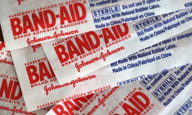 Johnson & Johnson To Split Into Two Publicly Traded Companies SAN ANSELMO, CALIFORNIA - NOVEMBER 12: In this photo illustration Johnson & Johnson band-aids are displayed on a table on November 12, 2021 in San Anselmo, California. Johnson & Johnson announced plans to split its pharmaceutical and medical devices divisions and consumer products into two publicly traded companies. The company hopes to complete the transaction within two years. (Photo Illustration by Justin Sullivan/Getty Images)