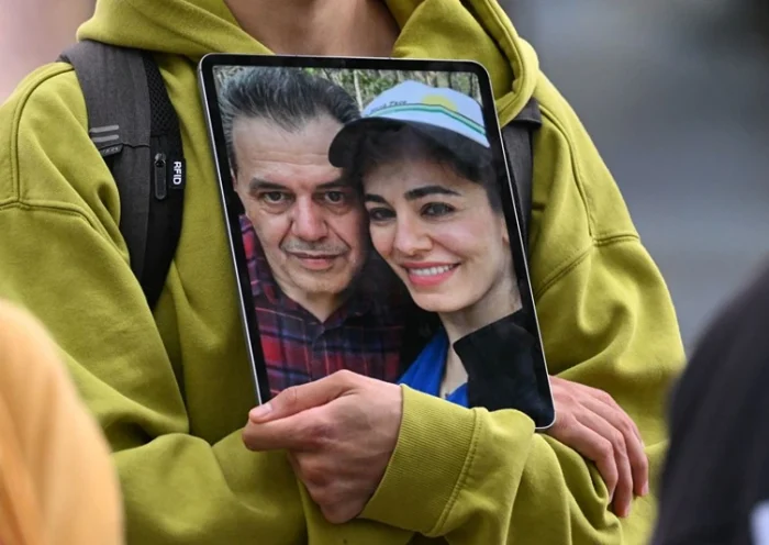 A demonstrator holds a picture of Iranian-German Jamshid Sharmahd (L), who has been sentenced to death in Iran, with his daughter Gazelle Sharmahd during a demonstration for his release in front of the German Foreign Ministry in Berlin on July 31, 2023. Sharmahd was abducted three years ago in late July 2020 by the Iranian authorities and sentenced earlier this year to be hanged for "corruption on earth". Iran's Supreme Court in April confirmed the death penalty. (Photo by INA FASSBENDER / AFP) (Photo by INA FASSBENDER/AFP via Getty Images)