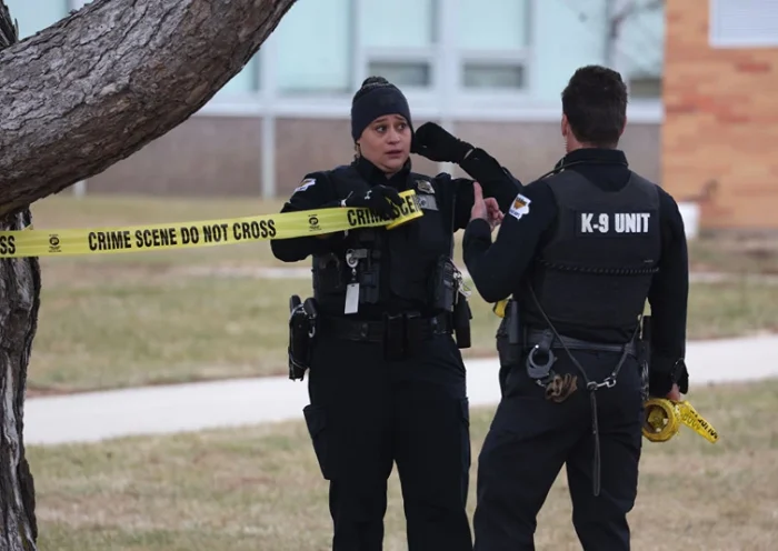 PERRY, IOWA - JANUARY 04: Law enforcement officials put up police tape at the Perry Middle School and High School complex in response to a school shooting on January 04, 2024 in Perry, Iowa. Students were returning to classes today following the holiday break. (Photo by Scott Olson/Getty Images)