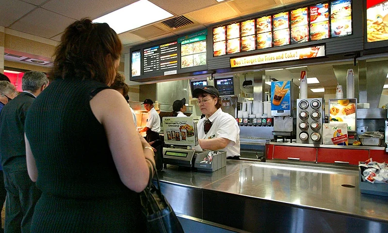 NILES, ILLINOIS - APRIL 30: People stand at a counter inside a McDonald's fast food restaurant April 30, 2003 in Niles, Illinois. McDonald's Corporation announced that results for the quarter that ended March 31 and showed a 7 percent gain in earnings per share (before the cumulative effect of accounting changes) on higher revenues. Comparable unit sales have declined. (Photo by Tim Boyle/Getty Images)