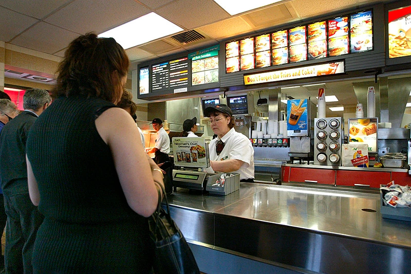 NILES, ILLINOIS - APRIL 30: People stand at a counter inside a McDonald's fast food restaurant April 30, 2003 in Niles, Illinois. McDonald's Corporation announced that results for the quarter that ended March 31 and showed a 7 percent gain in earnings per share (before the cumulative effect of accounting changes) on higher revenues. Comparable unit sales have declined. (Photo by Tim Boyle/Getty Images)