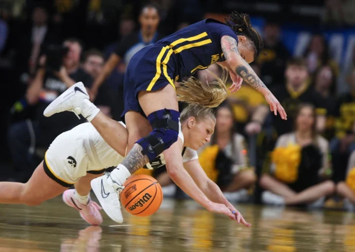 IOWA CITY, IOWA- MARCH 25: Guard Sydney Affolter #3 of the Iowa Hawkeyes battles for a loose ball in the first half against guard J.J. Quinerly #11 of the West Virginia Mountaineers during their second round match-up in the 2024 NCAA Division 1 Womens Basketball Championship at Carver-Hawkeye Arena on March 25, 2024 in Iowa City, Iowa. (Photo by Matthew Holst/Getty Images)