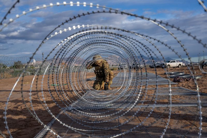EL PASO, TEXAS - APRIL 02: A Texas National Guard soldier installs border fencing layered with concertina wire near the Rio Grande river on April 02, 2024 in El Paso, Texas. Last week, hundreds of migrants seeking asylum clashed with Texas national guardsmen while waiting to turn themselves in to border patrol agents for processing. Texas continues awaiting a verdict on Senate Bill 4. Attorneys representing the state of Texas are scheduled to return to the Fifth Circuit Court of Appeals in New Orleans on April 3 to continue arguing for the constitutional basis of the bill. Senate Bill 4 allows state law enforcement officials to detain and arrest undocumented immigrants suspected of illegally crossing into the United States. Thus far, all prior attempts to put the Bill into effect have been blocked by the Fifth Circuit Court of Appeals. (Photo by Brandon Bell/Getty Images)