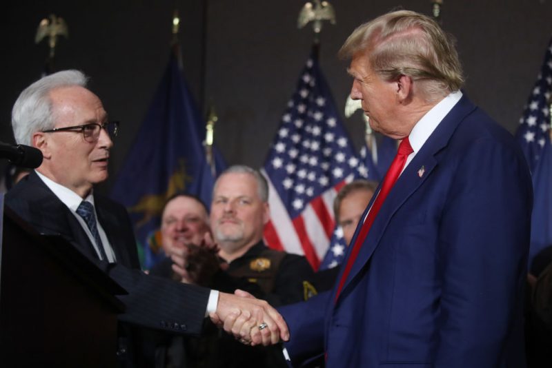 GRAND RAPIDS, MICHIGAN - APRIL 02: Former U.S. President Donald Trump speaks with James Tignanelli, with the Police Officers Association of Michigan as he attends a campaign event on April 02, 2024 in Grand Rapids, Michigan. Trump delivered a speech which his campaign has called 
