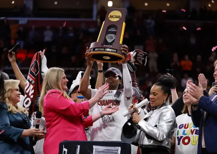 CLEVELAND, OHIO - APRIL 07: Sania Feagin #20 of the South Carolina Gamecocks hoists the trophy after beating the Iowa Hawkeyes in the 2024 NCAA Women's Basketball Tournament National Championship at Rocket Mortgage FieldHouse on April 07, 2024 in Cleveland, Ohio. South Carolina beat Iowa 87-75 (Photo by Gregory Shamus/Getty Images)