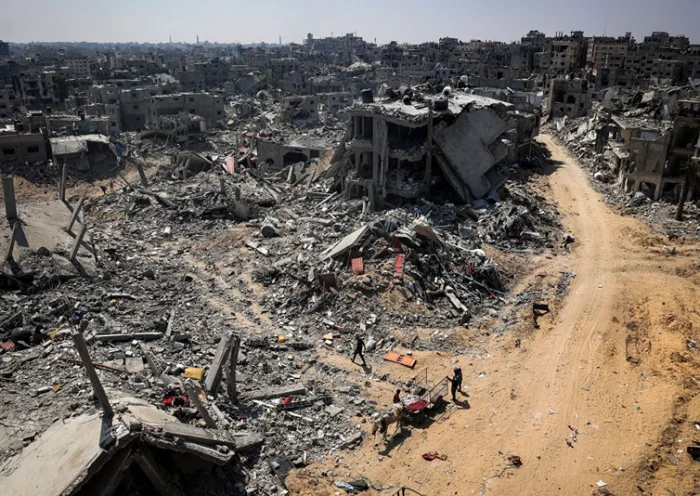 TOPSHOT - People look for salvageable items amid the rubble of buildings destroyed during Israeli bombardment in Khan Yunis, on the southern Gaza Strip on April 16, 2024, as fighting continues between Israel and the Palestinian militant group Hamas. (Photo by AFP) (Photo by -/AFP via Getty Images)