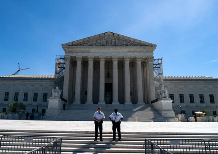 WASHINGTON, DC - APRIL 16: Supreme Court Police officers stand on the steps of the nation's high court as supporters of January 6 defendants including Micki Witthoeft, the mother of Ashli Babbitt, who was killed on January 6, 2021, gather outside of the Supreme Court on April 16, 2024 in Washington, DC. The Supreme Court is hearing oral arguments in Fischer v. U.S., a case about whether the U.S. Court of Appeals for the District of Columbia Circuit erred in applying a specific part of U.S. criminal code when charging January 6 defendants. (Photo by Kent Nishimura/Getty Images)