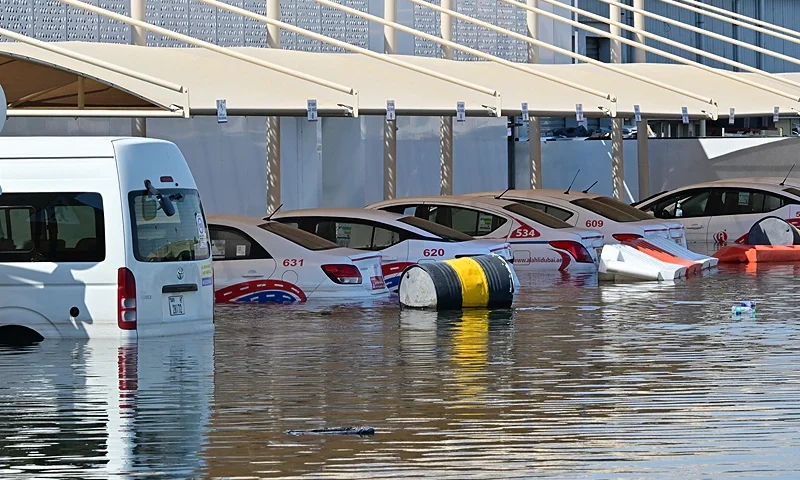 Cars are seen in flooded parking lot in Dubai following heavy rains on April 18, 2024. Dubai's giant highways were clogged by flooding and its major airport was in chaos as the Middle East financial centre remained gridlocked on April 18, a day after the heaviest rains on record. (Photo by Giuseppe CACACE / AFP) (Photo by GIUSEPPE CACACE/AFP via Getty Images)