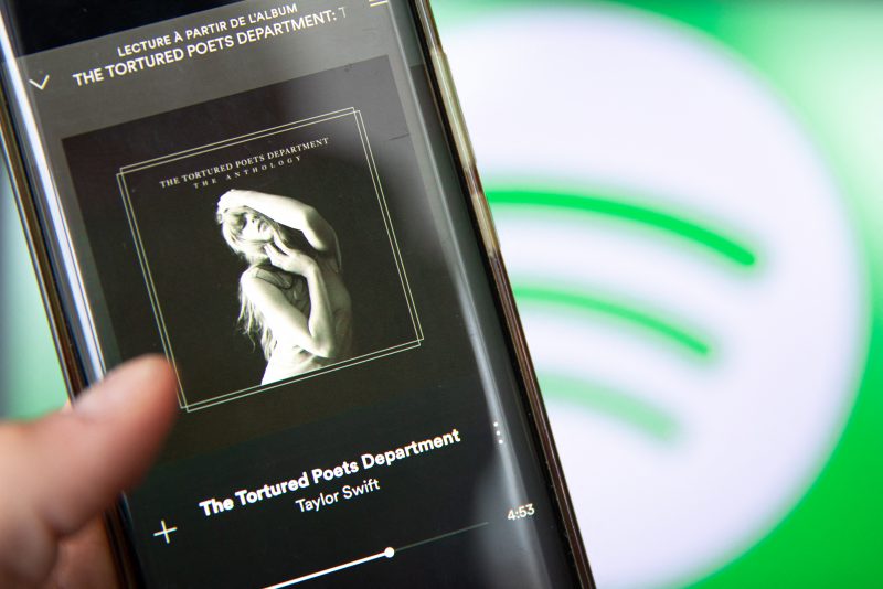 This photograph taken in Paris on April 19, 2024, shows a smatphone displaying the US singer-songwriter Taylor Swift's new album "The Tortured Poets Department" on Spotify. Queen of pop Taylor Swift released her highly anticipated record "The Tortured Poets Department" on April 19, 2024 -- the 11th studio album from the megastar who is already having a blockbuster year. Swift announced the album's release at the Grammys in February, a night that saw the 34-year-old billionaire win a record-breaking fourth Album of the Year prize. (Photo by Antonin UTZ / AFP) (Photo by ANTONIN UTZ/AFP via Getty Images)