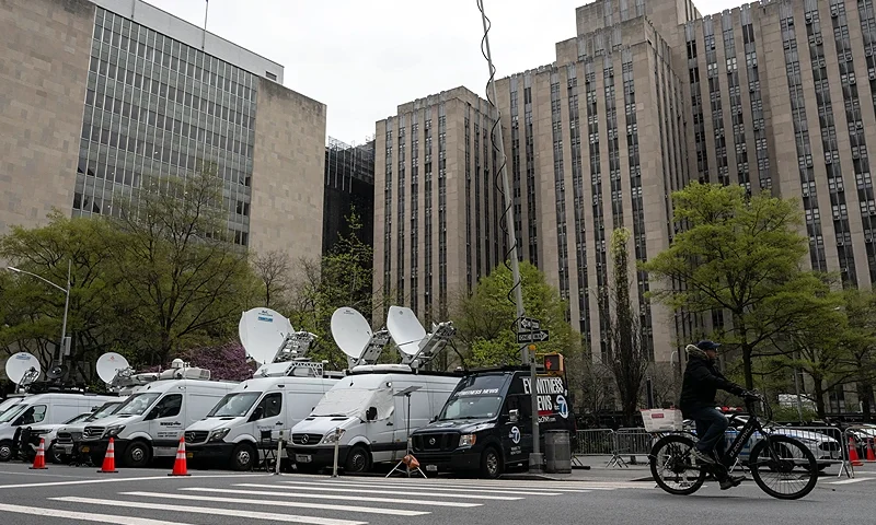 Media vehicles are parked outside of the Manhattan Criminal Court building as former US President Donald Trump attends his trial for allegedly covering up hush money payments linked to extramarital affairs, in New York City on April 19, 2024. A panel of 12 jurors was sworn in on April 18, 2024, for the unprecedented criminal trial of a former US president. (Photo by ANGELA WEISS / AFP) (Photo by ANGELA WEISS/AFP via Getty Images)