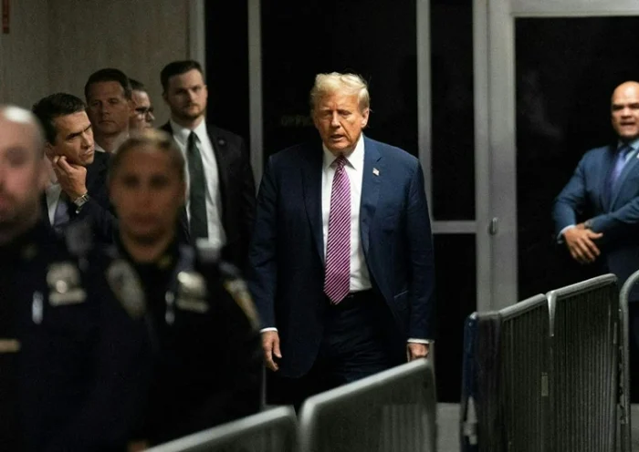 Former US President Donald Trump (C) departs the courtroom for the day at Manhattan Criminal Court during his trial for allegedly covering up hush money payments linked to extramarital affairs, in New York City on April 19, 2024. A panel of 12 jurors was sworn in on April 18, 2024, for the unprecedented criminal trial of a former US president. (Photo by Maansi Srivastava / POOL / AFP) (Photo by MAANSI SRIVASTAVA/POOL/AFP via Getty Images)