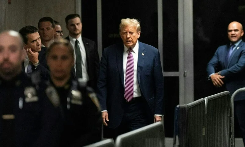 Former US President Donald Trump (C) departs the courtroom for the day at Manhattan Criminal Court during his trial for allegedly covering up hush money payments linked to extramarital affairs, in New York City on April 19, 2024. A panel of 12 jurors was sworn in on April 18, 2024, for the unprecedented criminal trial of a former US president. (Photo by Maansi Srivastava / POOL / AFP) (Photo by MAANSI SRIVASTAVA/POOL/AFP via Getty Images)