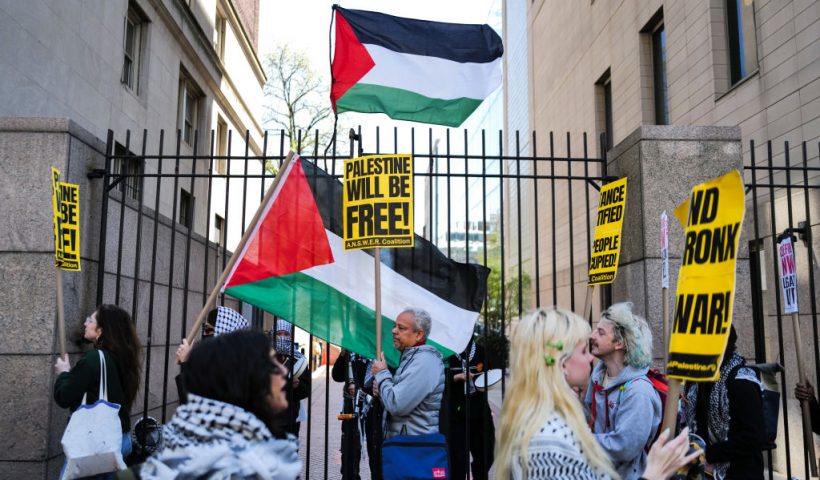 Pro-Palestinian supporters wave flags in front of the entrance of Columbia University which is occupied by pro-Palestine protesters in New York on April 22, 2024. US President Joe Biden condemned any anti-Semitism on college campuses April April 21, 2024 as pro-Palestinian protesters at Columbia University spent their fifth day demanding the school sever financial ties with key US ally Israel. (Photo by Charly TRIBALLEAU / AFP) (Photo by CHARLY TRIBALLEAU/AFP via Getty Images)