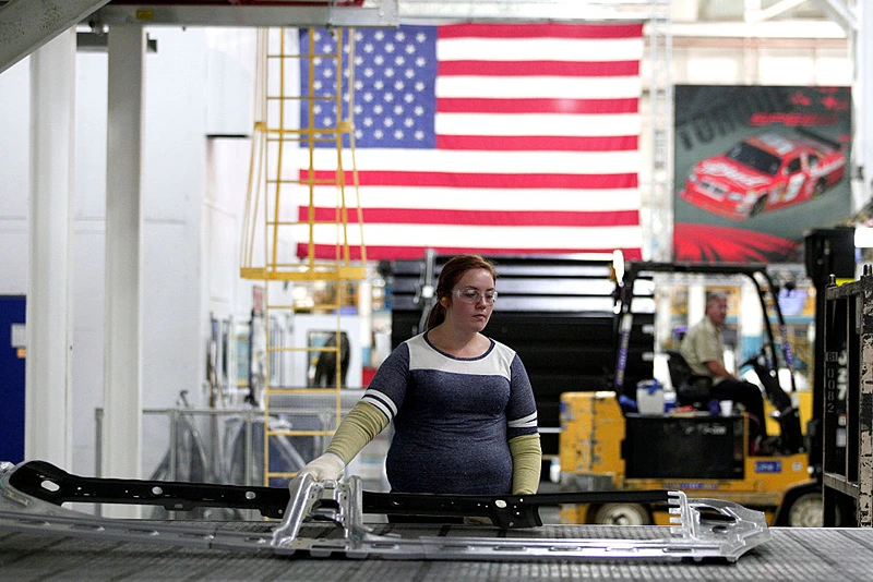STERLING HEIGHTS, MI - AUGUST 26:  A worker handle parts for Fiat Chrysler Automobiles as they come off the press at the FCA Sterling Stamping Plant August 26, 2016 in Sterling Heights, Michigan. An event was held today at the plant to celebrate the start of production of three all-new stamping presses, whose installation began in July 2015 and cost $166 million. (Photo by Bill Pugliano/Getty Images)