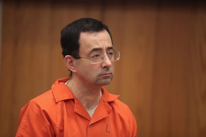 Dr. Larry Nassar Faces Sentencing At Second Sexual Abuse Trial
CHARLOTTE, MI - FEBRUARY 05: Larry Nassar stands as he is sentenced by Judge Janice Cunningham for three counts of criminal sexual assault in Eaton County Circuit Court on February 5, 2018 in Charlotte, Michigan. Nassar has been accused of sexually assaulting more than 150 girls and young women while he was a physician for USA Gymnastics and Michigan State University. Cunningham sentenced Nassar to 40 to 125 years in prison. He is currently serving a 60-year sentence in federal prison for possession of child pornography. Last month a judge in Ingham County, Michigan sentenced Nassar to an 40 to 175 years in prison after he plead guilty to sexually assaulting seven girls. (Photo by Scott Olson/Getty Images)