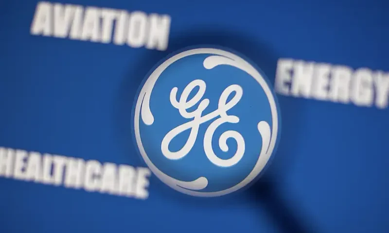 General Electric logo is seen through magnifier in front of displayed Aviation, Energy, Healthcare words in this illustration taken, November 9, 2021. REUTERS/Dado Ruvic/Illustration/File Photo