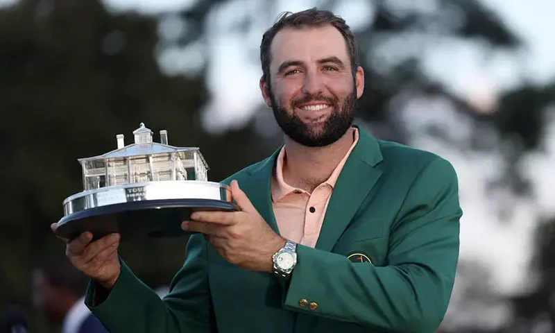 Scottie Scheffler of the U.S. celebrates with his green jacket and the trophy after winning The Masters at Augusta National Golf Club, Augusta, Georgia. REUTERS/Mike Segar
